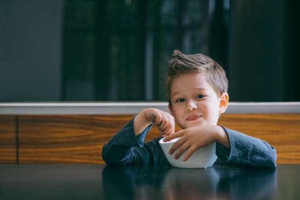 Boy at home eating and having fun.