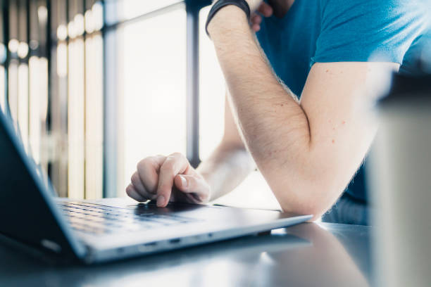 istock close up man hand use laptop with light from window background 1148643413