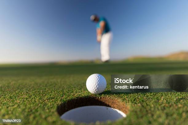 Golf Ball Entering The Hole After Successful Stroke Close Up Links Golf Stock Photo - Download Image Now