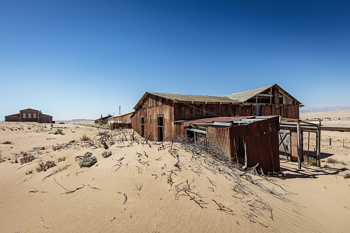 Abandoned Diamond Mine Ghost Town House in between Namib Desert Sand Dunes. Lüderitz, Namibia, Africa