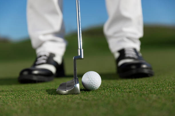 istock Golfer teeing off the ball - ready for putt - links golf 1148645292