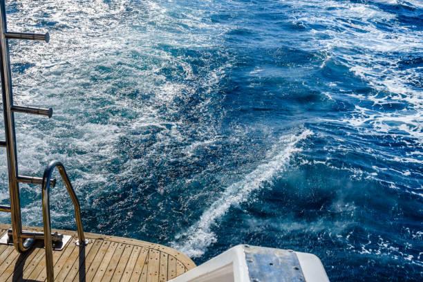 istock Wave trace with white foam on a water surface behind of fast moving yacht 1148645591