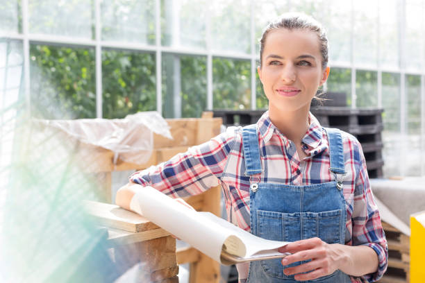 istock Thoughtful farmer reading report on clipboard in greenhouse 1148647626