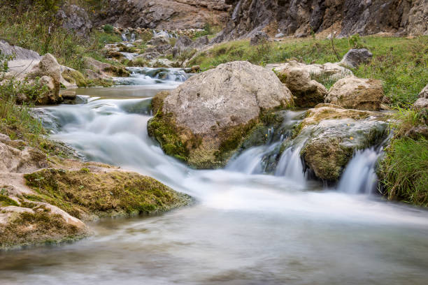 Long exposure mountain creek cascading through the rocks in a canyon