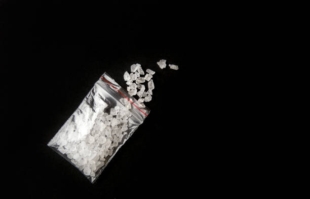 conceptual image of "bath salts" synthetic cathinones drugs narcotics concept. white crystal powder on black background( set up), resemble to bathroom bath salt. - bath salt imagens e fotografias de stock