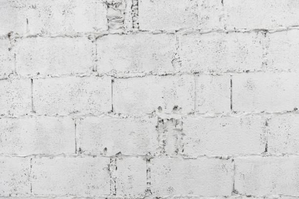 istock closeup of white decay brick wall abstract background wallpaper or web banner with copy space. 1148649774