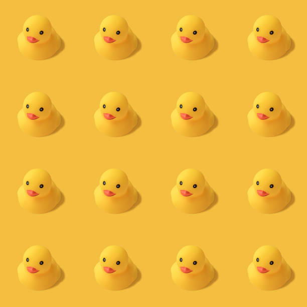 istock repeatable pattern of yellow rubber duck on yellow background Modern style. creative photography. 1148650091