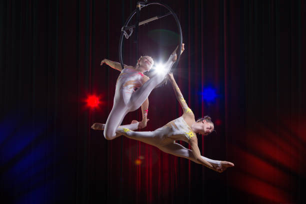 istock Circus actress acrobat performance. Two girls perform acrobatic elements in the air ring. 1148651287