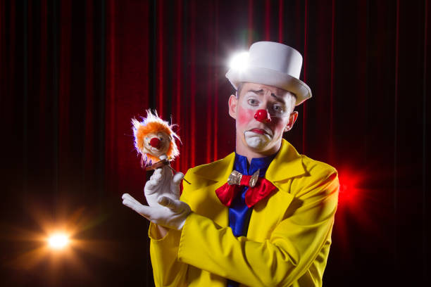istock Circus clown performs number. A man in a clown outfit with a toy 1148651393