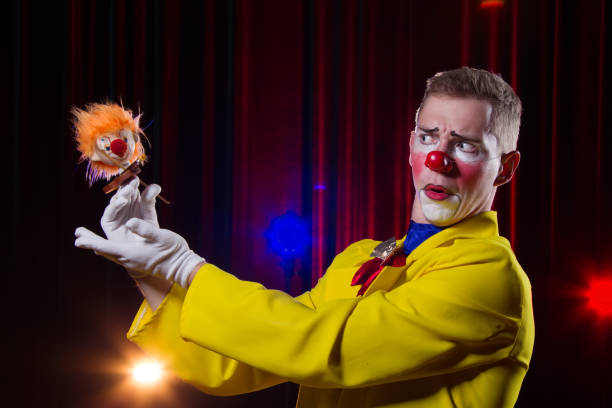 istock Circus clown performs number. A man in a clown outfit with a toy 1148651414