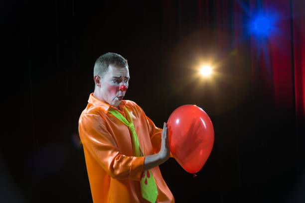 istock Circus lown performs number. A man in a clown outfit with a balloon 1148651783