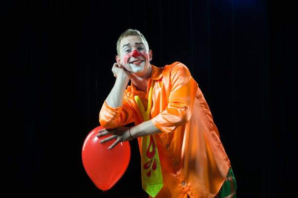 istock Circus lown performs number. A man in a clown outfit with a balloon 1148651797