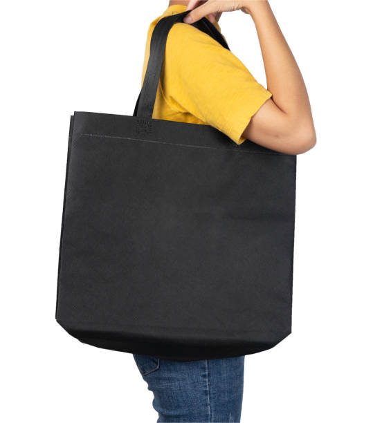 istock Woman holding blank black fabric canvas bag isolated on white background with clipping path, eco concept 1148651807