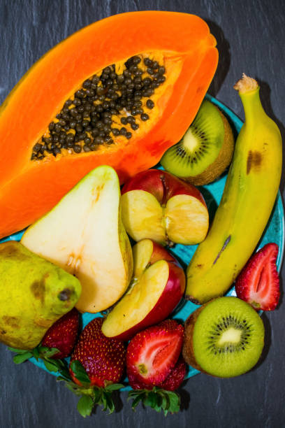 istock Mixed fruit on a plate, healthy food concept 1148653035