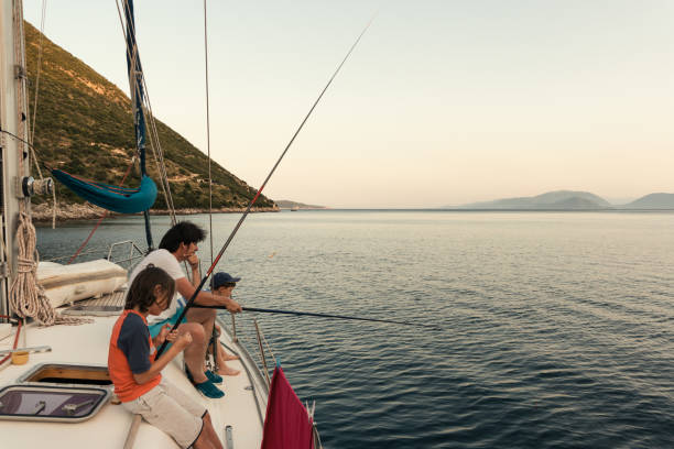 istock Father fishing with sons on sailboat 1148653405