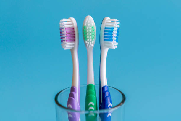 istock Toothbrushes on blue background. Flat lay composition with manual toothbrushes on color background, close up. 1148653553
