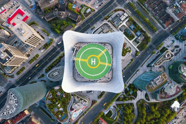 Aerial view of helipad. Helicopter landing pad on rooftop on skyscraper, high-rise office building in Shanghai Downtown, China. Financial district and business centers in smart city in Asia.