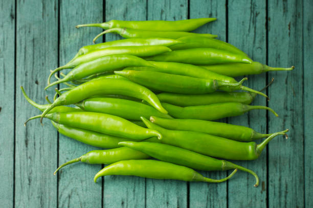 Close-Up Of Green Chili Pepper Close-Up Of Green Chili Pepper green chilli pepper stock pictures, royalty-free photos & images