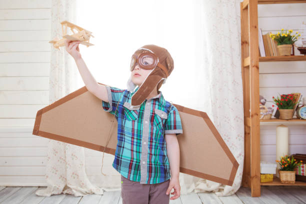 istock Little boy playing with wooden model airplane 1148660177