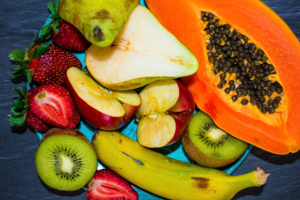 istock Mixed fruit on a plate, healthy food concept 1148660286