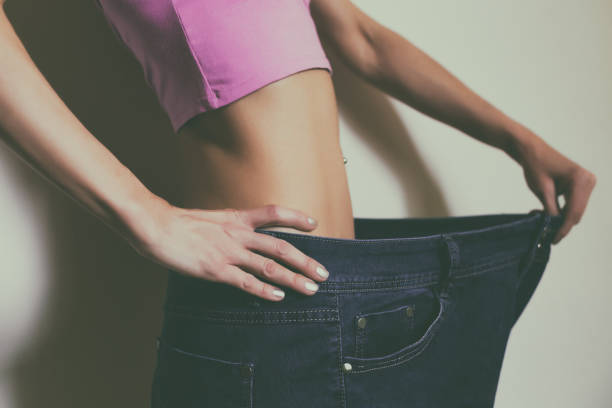 istock Woman in oversized jeans,weight loss concept 1148661457