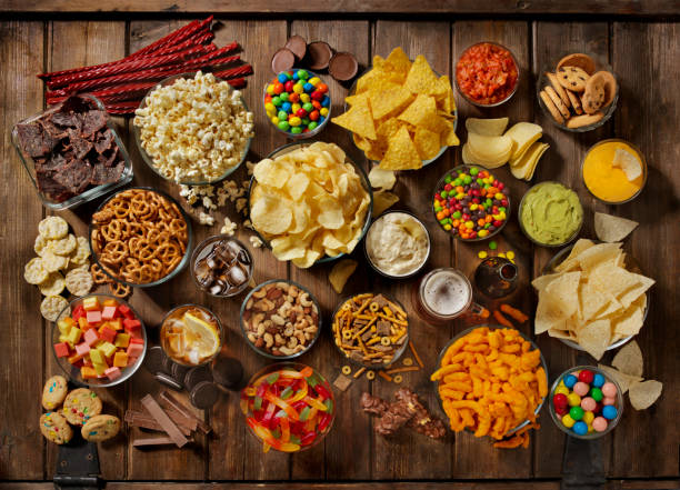 group of sweet and salty snacks, perfect for binge watching - pretzel snack salty food imagens e fotografias de stock