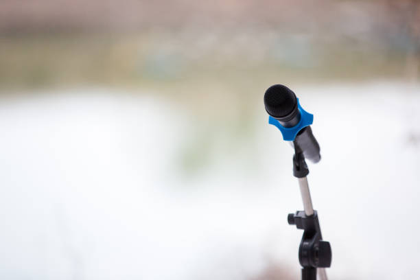 istock microphone with light in concert hall or conference room soft and blur style for background. 1148662639