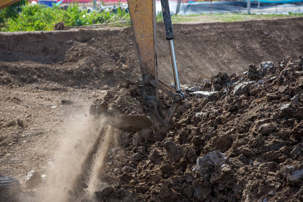 istock Building Machines: Digger loading trucks with soil. Excavator loading sand into a dump truck. Work in the quarry. Excavator Loading Dumper Truck at Construction Site. 1148662765