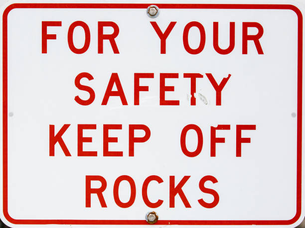 istock Grungy Sign -- For Your Safety Keep Off Rocks 1148662850