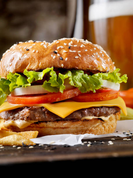 Classic Cheeseburger on a Brioche Bun with a Beer and Fries
