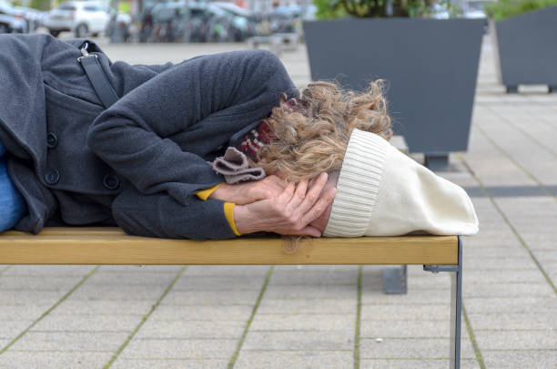 istock Homeless woman sleeping rough on a bench 1148667035