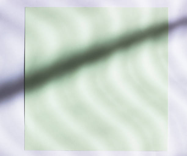 istock Empty sheet of paper for writing with wavy shadows. Preparing for a postcard from green paper with shadows. Layout for adding tags. Natural hard light, deep shadows. Top view, flat lay, copy space 1148667907