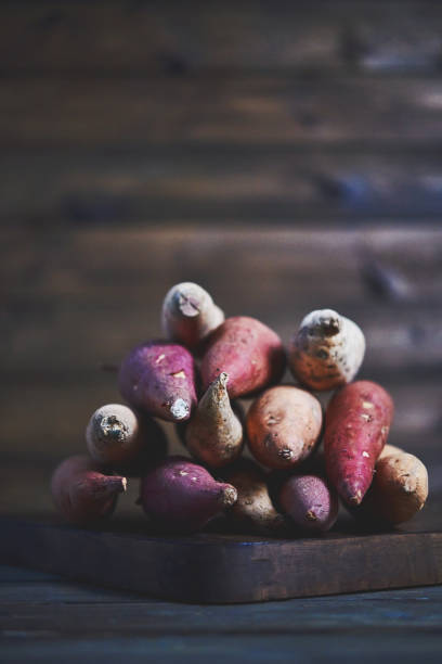 Still life of assorted potatoes shot in dark moody light