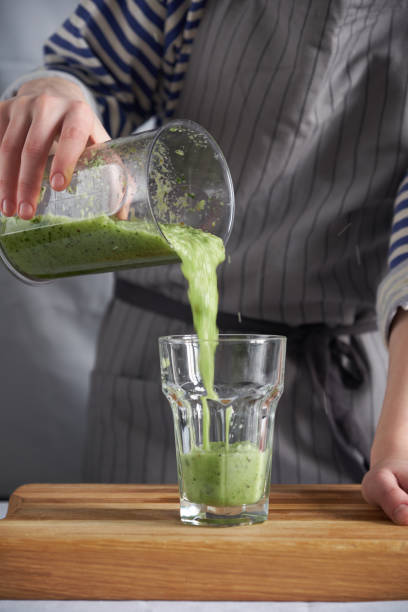 istock Pouring fresh smoothie into a glass 1148671999