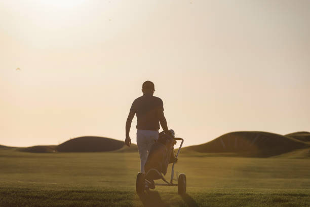 istock Golf player is turning back after game finished - links golf 1148673702