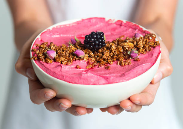 Smoothie Bowl Woman giving smoothie bowl. Smoothie Bowl stock pictures, royalty-free photos & images