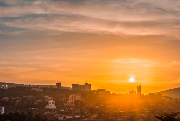 Kigali city centre skyline and surrounding areas under a golden sky at sunset Kigali city centre skyline and surrounding areas under a golden sky at sunset rwanda photos stock pictures, royalty-free photos & images