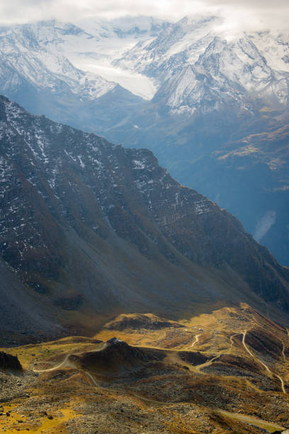 Electricity transmission to the most remote places.Here the line is near a larch forest (mélézin)