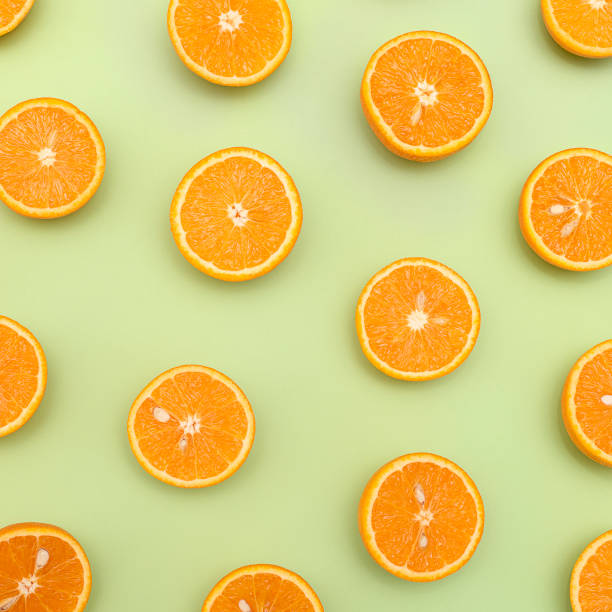 istock Orange juicy oranges split in half on green 1148678398