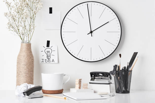 istock Office supplies and wall clock on white 1148678614