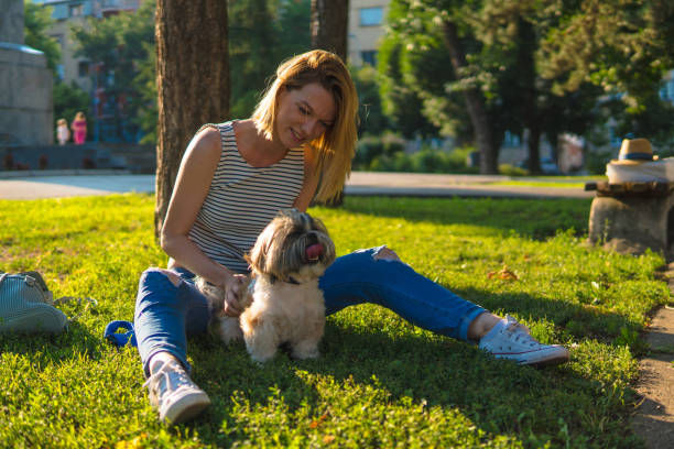 istock Woman with dog in a park 1148680420