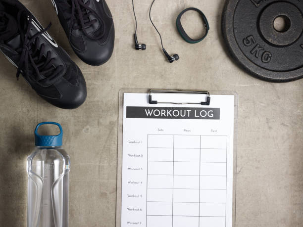 istock Closeup on black sneakers and workout log in clipboard 1148681101