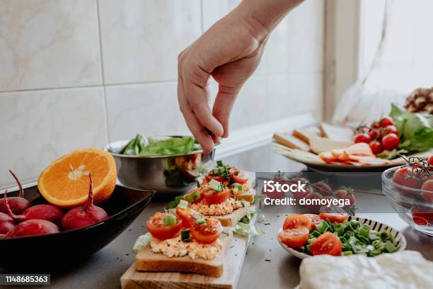 Seasoning Tasty Bruscheta In The Kitchen Stock Photo - Download Image Now - Healthy Eating, Cooking, Healthy Lifestyle