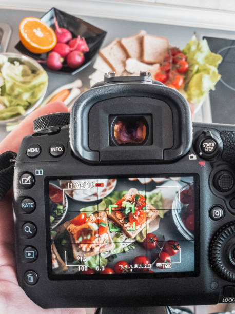 istock Photographing bruschetta with cherry and mozzarella in the kitchen 1148685406