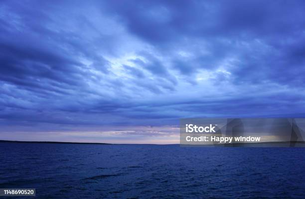 Dramatic Sky And Sea In Dark Blue Color Tone Seascape Horizon After Storm Stock Photo - Download Image Now
