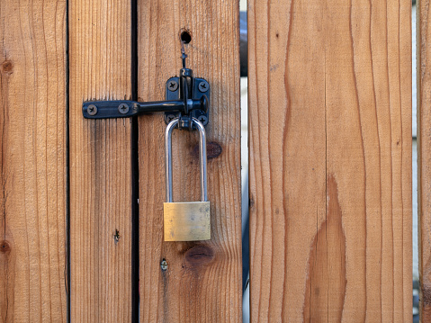 Lock hanging from a latch on a gate