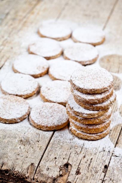 istock Fresh baked oat cookies with sugar powder on rustic wooden table. 1148694171