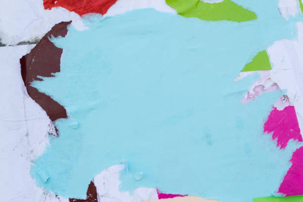 istock Scraps of colored paper pasted on the wall. 1148697848