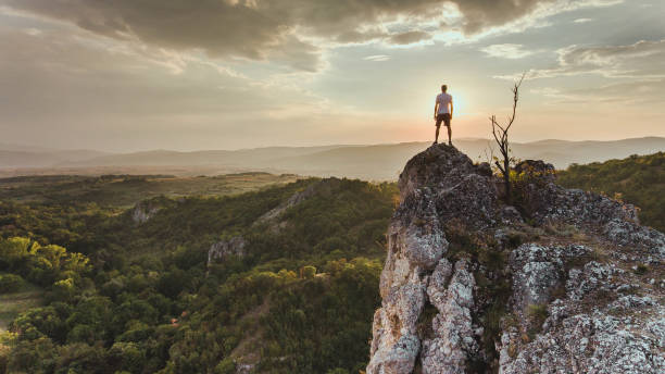 istock Man reaching summit enjoying freedom. 1148699757