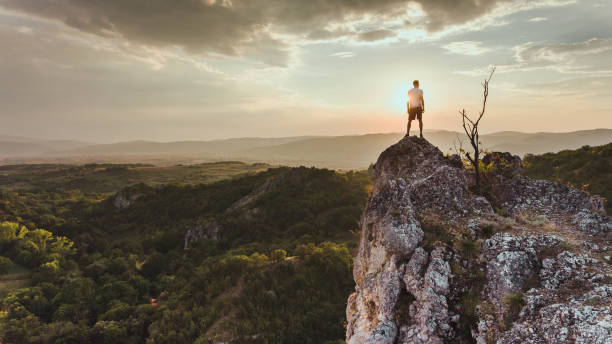 istock Man reaching summit enjoying freedom. 1148700301